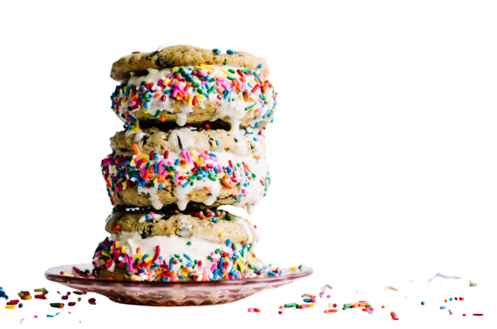Ice cream between fresh-baked cookies rolled in sprinkles